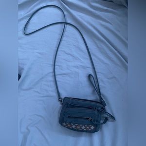 small crossbody bag, colorful stitching and lots of zippers/pockets